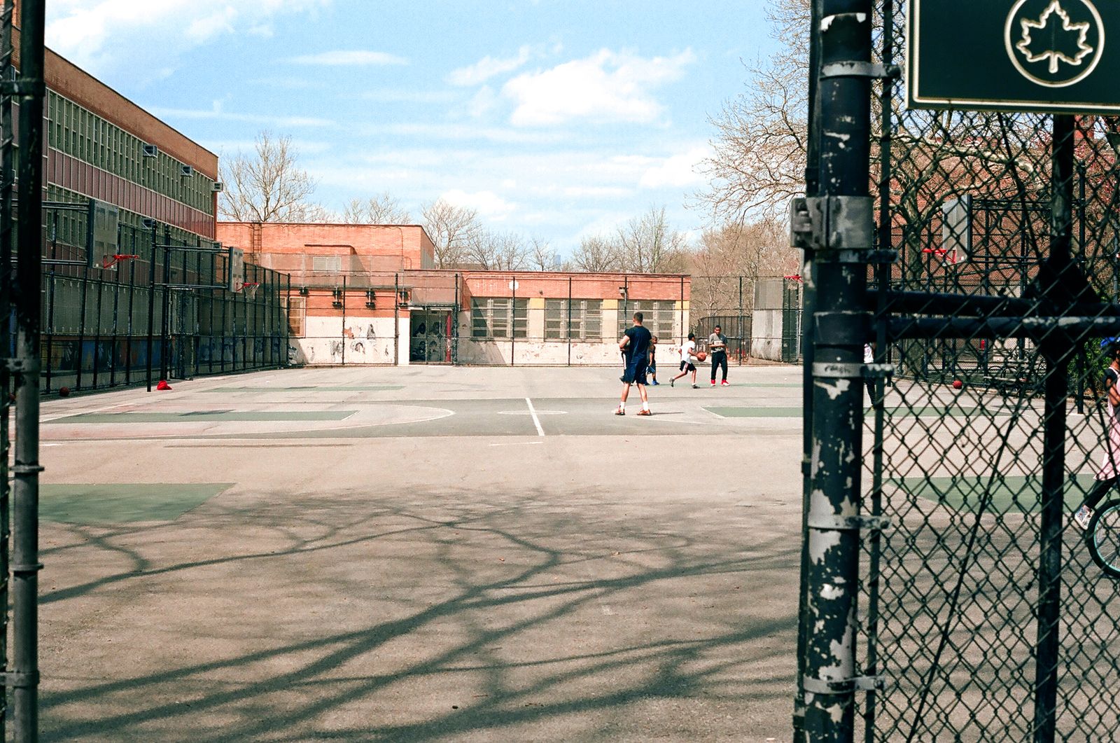 Children playing basketball on a court in Brooklyn, New York