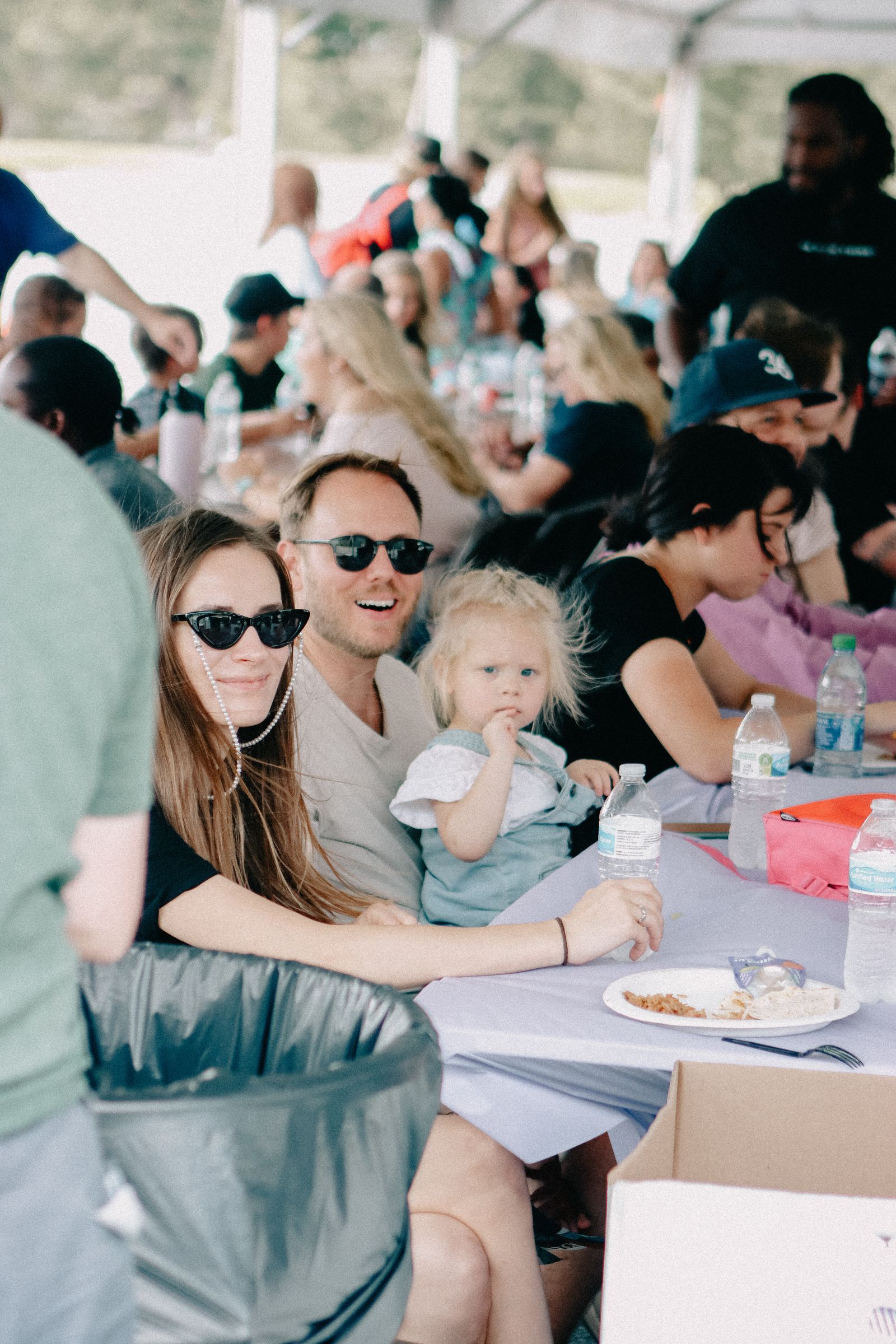 A family attending an outdoor community gathering